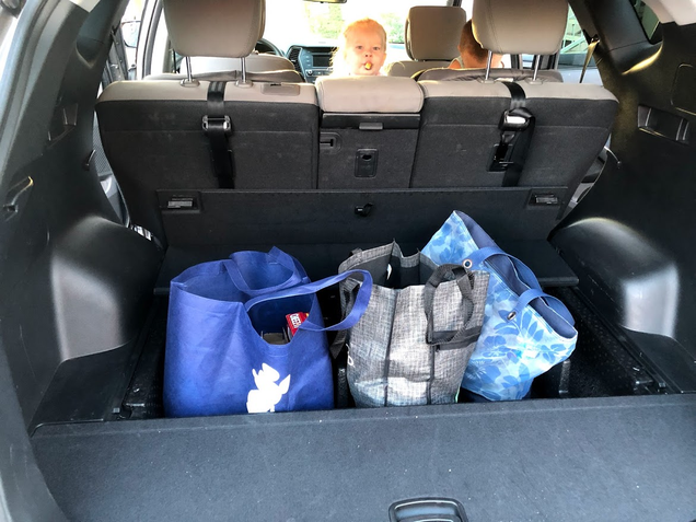 The under tray in the cargo area fit bags rather well. Keeps them from sliding about too.